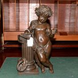 A bronze figure of a putti leaning on a pedestal and books