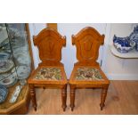 A pair of Victorian oak Gothic Revival hall chairs