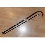 A dog head walking cane, set with glass eyes and silver collar, together with a silver capped stick,