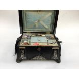 A mid 19th century, Japanned sewing box with mother of pearl inlay, content include,