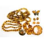 A Continental sterling silver oval brooch set amber, two amber bracelets,