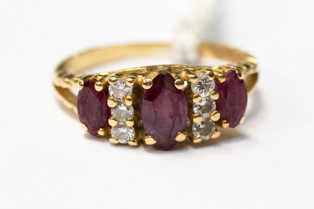 An 18ct gold ring set with rubies and diamonds,