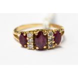 An 18ct gold ring set with rubies and diamonds,