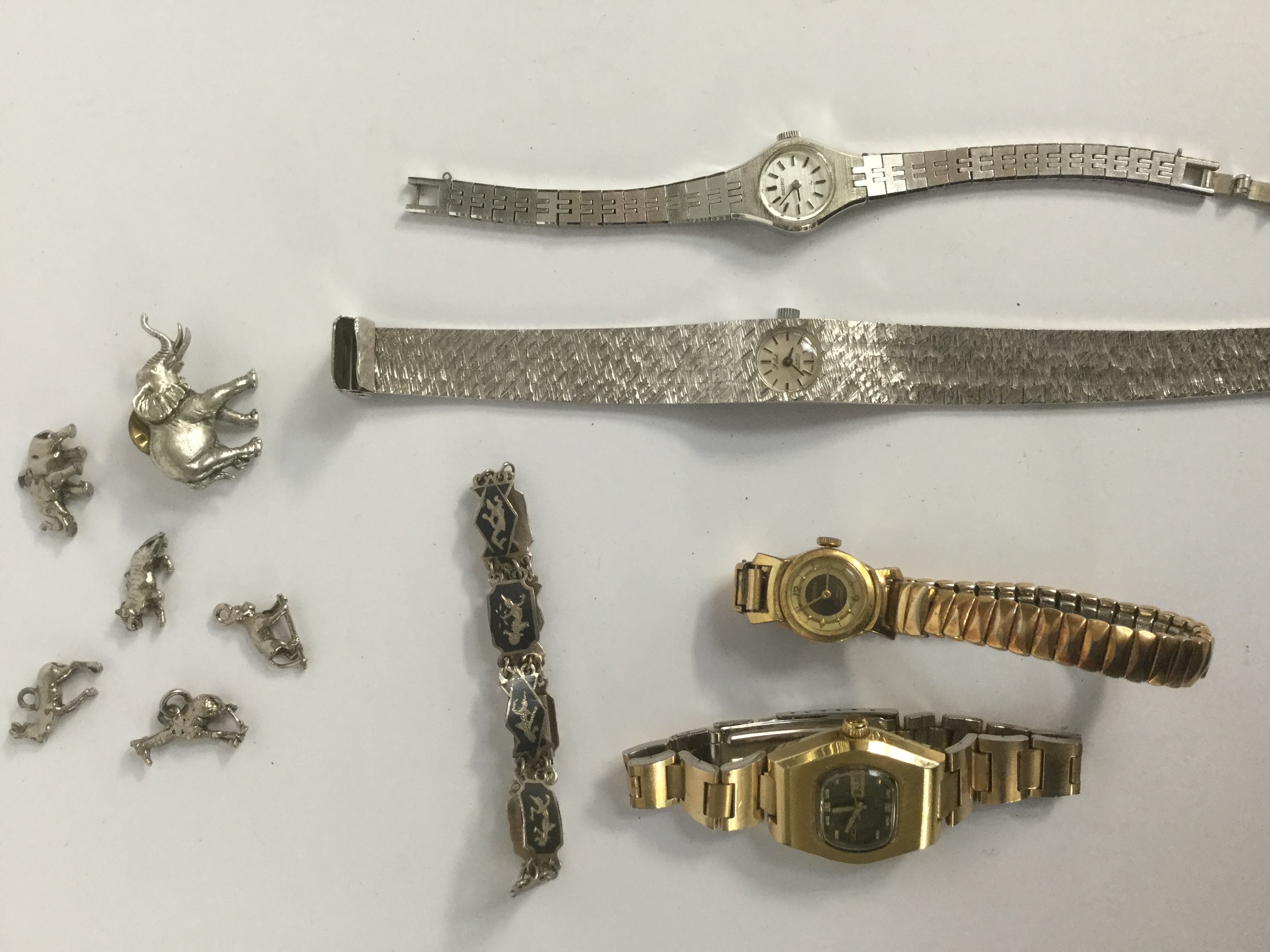 Ladies watches and silver charms;