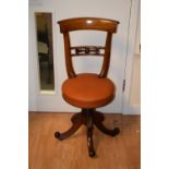 An early Victorian rosewood revolving piano chair, circa 1835,