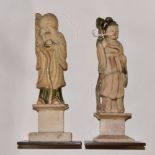 A pair of Chinese 17th century or later soap stone carved figures of immortals,