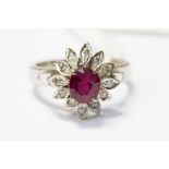 A ruby and 18ct stamped white gold flower cluster ring,