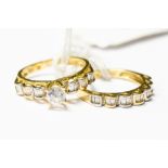 A pair of 18ct gold rings set with white topaz stones,