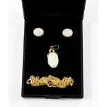 A precious white opal pendant with matching earrings set in 18ct gold along with two chains in 9ct