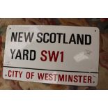 An enamel New Scotland Yard SW1 sign