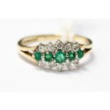 An emerald and diamond cluster ring set in 9ct gold,