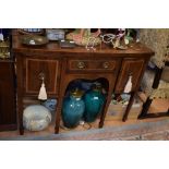A George III style mahogany sideboard, of bow fronted form, 120cm high, 123cm wide,