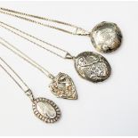 A group of three silver lockets with various designs including a Clogau locket depictiong flowers
