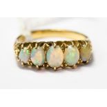 A five stone graduated opal ring set in 18ct gold, size M, with a total gross weight approx 4.3gms.