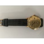 An Omega Automatic wristwatch with yellow metal case and dial,