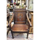 A late 17th Century joined oak wainscot armchair, rosette carved crest rail, arcaded panel to back,