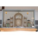 A late 19th or early 20th Century house diorama in a blue painted glazed case,