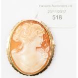 A large shell cameo brooch with a 9ct gold surround, depicting a lady,