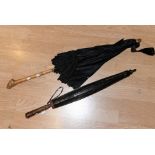 A Victorian silk mourning parasol with gnarled bamboo handle, green silk lining,