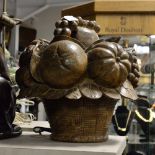 A large decorative basket of fruit carved from hardwood