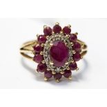 A ruby cluster ring set in yellow metal,