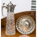 A silver plated and cut glass claret jug;