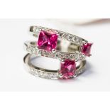 A pink tourmaline and diamond set three split row 18ct white gold band ring,