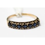 A sapphire and 9ct gold half eternity ring, claw set with seven round cut sapphires,