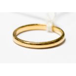 A 22ct gold band, width approx 2mm, size Q, weighing approx 3.