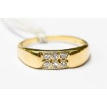 An 18ct gold ring pave set with six small diamonds, approx 0.