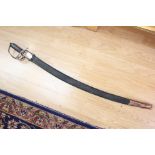 An Indian made decorative sword. 78cm curved blade with etched decoration. Complete with scabbard.