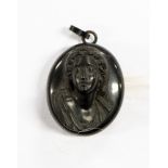 A Victorian jet oval locket with carved bust head to front