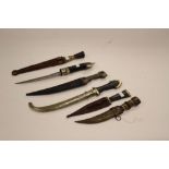 A collection of six Caucasian and Middle Eastern daggers. One without scabbard.