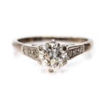 A diamond solitaire 18ct white gold ring with diamond set shoulders,