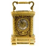 A late 19th Century brass repeating carriage clock, corniche case with bow sides,