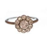 A diamond flower head cluster 18ct white gold ring, centre diamond weighing approximately 0.