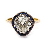 A diamond solitaire ring with blue sapphire border surround,