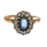 A sapphire and diamond oval cluster 18ct gold ring,