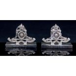 A pair of George V silver menu holders, cast in the form of Royal Artillery cap badges,