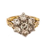 A diamond seven stone flower head cluster 18ct yellow gold ring,