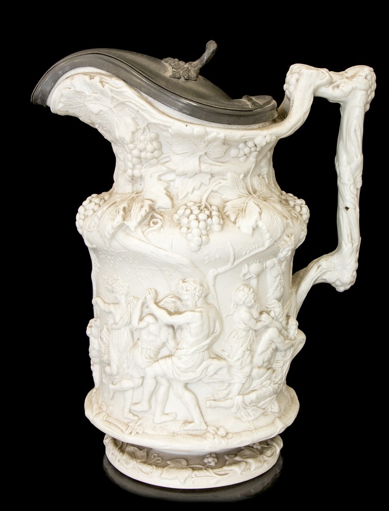 A Staffordshire moulded Stoneware jug with pewter cover,