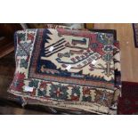 A cream ground and blue decorated woollen rug,