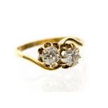 A diamond two stone 18ct yellow gold crossover ring,