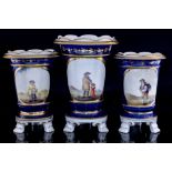 A Staffordshire garniture of vases each with painted vignettes of peasant figures in spartan