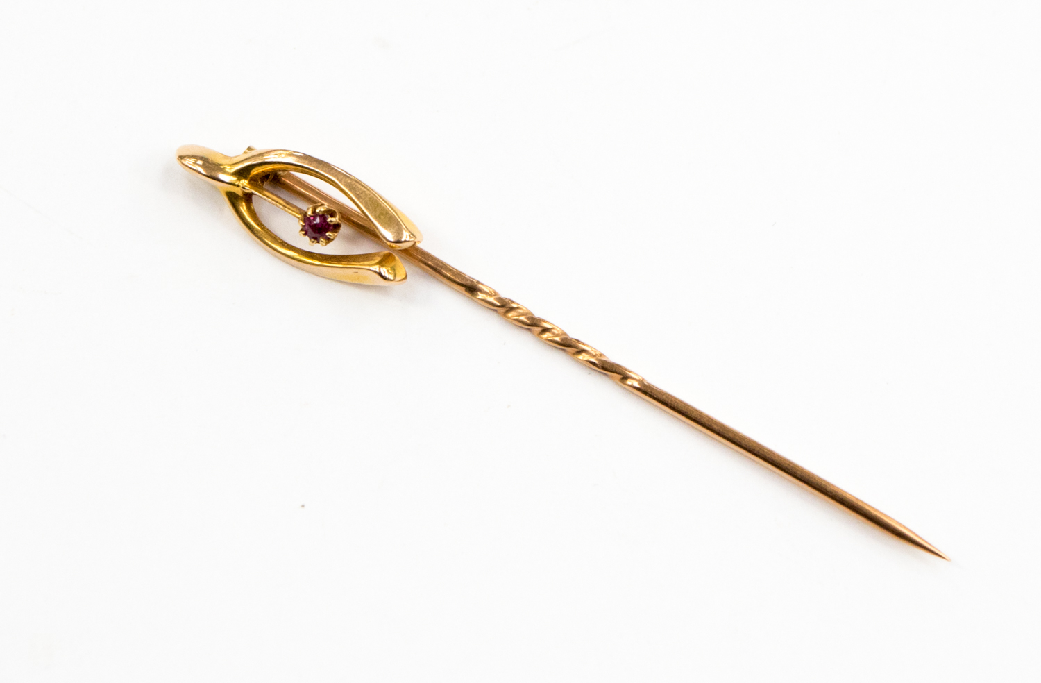 A 9ct gold stick pin with finial wish bone shape,