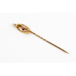 A 9ct gold stick pin with finial wish bone shape,
