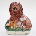 An early Staffordshire flatback, a lion seated on an official,