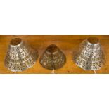 A set of three white metal pierced lamp shades of various sizes, total weight 229 grams/7.