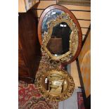 An oval mahogany framed mirror;