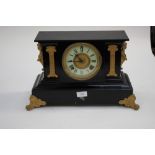 A large slate mantle clock with marble pillars to front,